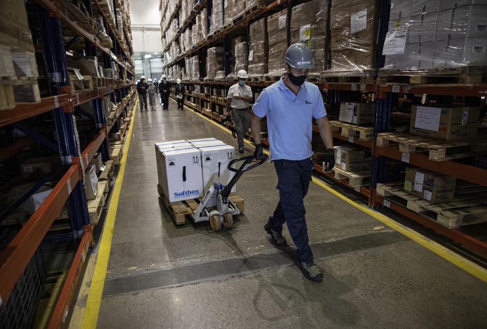 warehouse worker moving Pfizer COVID-19 vaccine